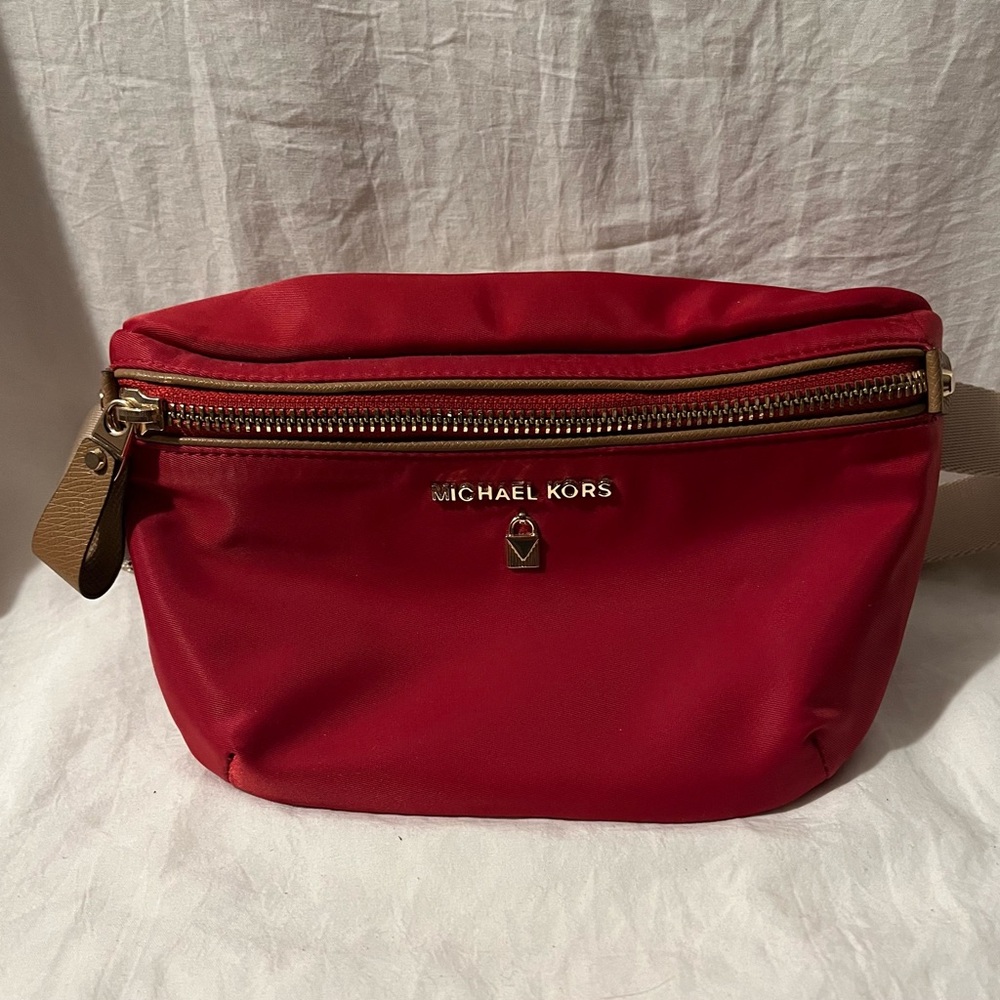 Red with gold buckle Michael Kors fanny pack.